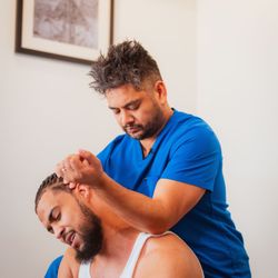 Empower Rehab & Wellness - Dr. Karpus stretching and massaging a patients neck