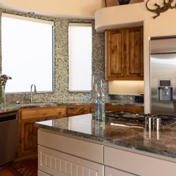 S Interior Design - A beautiful glass mosaic backsplash tile was installed at the sink area that pulls a favorite color into the kitchen area.