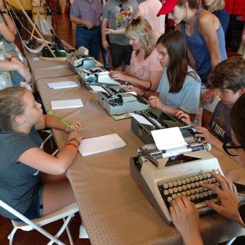 Maker Faire - Kids trying out typewriters. Fun watching them get to next line & how to remove paper. One wanted to know where "print" key was located! - Festivals Near Me - Dearborn, Michigan