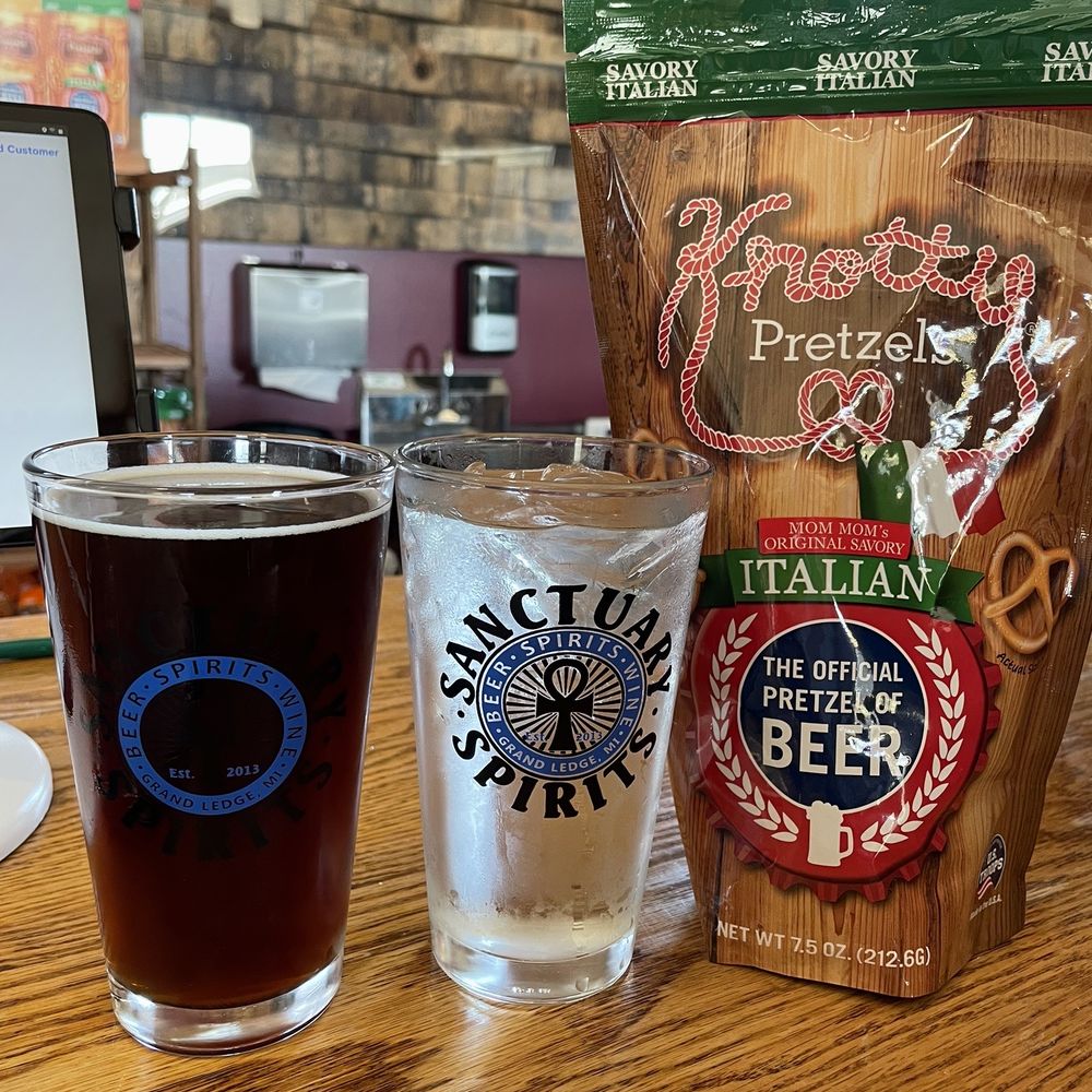two glasses of beer and a bag of pretzels two glasses of beer and a bag of pretzels