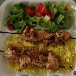 Zaroob Food Truck - Two chicken kabobs over rice, with salad.