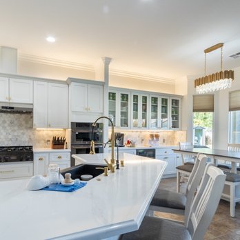 Coast Design and Build - a kitchen with white cabinets and a large island - General Contractors Near Me - Carlsbad, California Coast Design and Build - a kitchen with white cabinets and a large island - General Contractors Near Me - Carlsbad, California