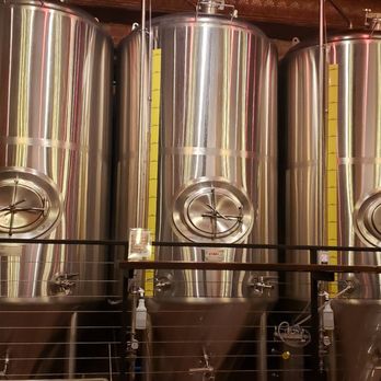 Spiral Brewery - a woman standing in front of a row of stainless steel tanks - Breweries Near Me - Hastings, Minnesota Spiral Brewery - a woman standing in front of a row of stainless steel tanks - Breweries Near Me - Hastings, Minnesota