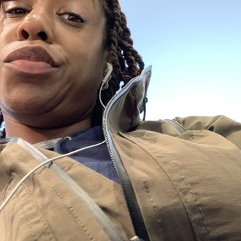 Jah Seal Mini Mart - a woman with earphones - Health Markets Near Me - New York, New York