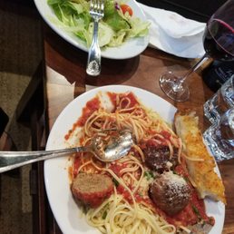 Tasty meatballs (3) and pasta and Greek salad with house dressing. Wine in the background