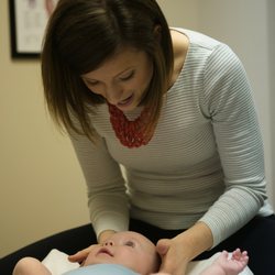 Full Motion Family Chiropractic - Dr. Jamie adjusting an infant patient. Adjustments for children are, gentle, safe and effective.