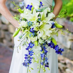 My stunningly perfect bridal bouquet of white roses, orchids, Oriental Lilies, and blue delphinium