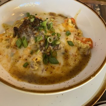 Common Restaurant  - Grits with cheese, beef that was seasoned amazingly and tender, egg, tomato, scallions, onions - Cocktail Bars Near Me - Savannah, Georgia