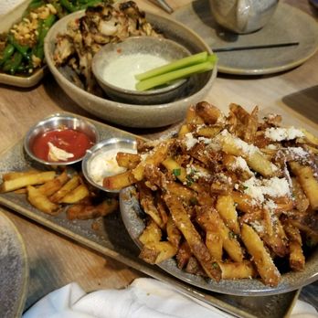 Moku Kitchen - Truffle fries that you absolutely can't stop eating, wings, green beans and a burger in the background - Cocktail Bars Near Me - Honolulu, Hawaii Moku Kitchen - Truffle fries that you absolutely can't stop eating, wings, green beans and a burger in the background - Cocktail Bars Near Me - Honolulu, Hawaii