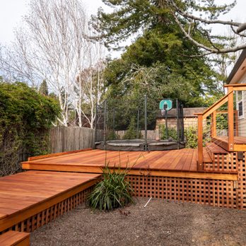 Christopher Stoehr Construction - Custom built Mahogany deck around a trampoline - Decks & Railing Near Me