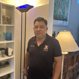 Juan Pineda, owner of Nowell's Lighting, next to his Italian light complicated repair. Juan Pineda, owner of Nowell's Lighting, next to his Italian light complicated repair.