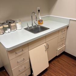 Rapid Care Urgent Care - Running faucet and a broken cabinet