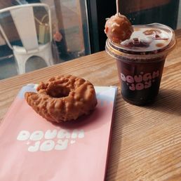 Apple cider old fashioned donut with an iced coffee. Apple cider old fashioned donut with an iced coffee.