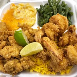 Fried conch and shrimp dinner over a bed of yellow rice along side our Mac n cheese and string beans