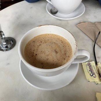 The Mercury Cafe And Teahouse - Oat milk latte with cinnamon on top - Vegetarian Near Me - New Castle, Delaware The Mercury Cafe And Teahouse - Oat milk latte with cinnamon on top - Vegetarian Near Me - New Castle, Delaware