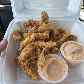 A&M Atlantic Seafood - a hand holding a container of fried chicken - Seafood Near Me - Cocoa, Florida A&M Atlantic Seafood - a hand holding a container of fried chicken - Seafood Near Me - Cocoa, Florida