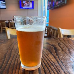 a glass of beer on a table a glass of beer on a table