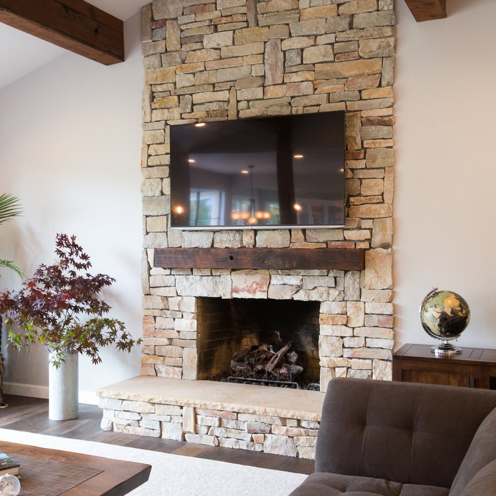 Bodas Construction - a living room with a stone fireplace - General Contractors Near Me Bodas Construction - a living room with a stone fireplace - General Contractors Near Me