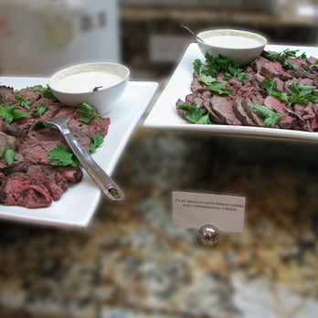 Greenleaf Platters - Platter of sliced filet mignon, fresh herbs and a horseradish cream on the side - Caterers Near Me