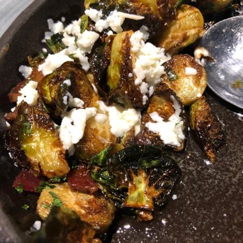 Uptown Kitchen + Taphouse - Zippin' Brussels Sprouts appetizer, partially eaten. Note the glorious amount of cheese! - Gastropubs Near Me - Rogers, Arkansas
