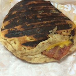 a closeup of a sandwich wrapped in wax paper a closeup of a sandwich wrapped in wax paper