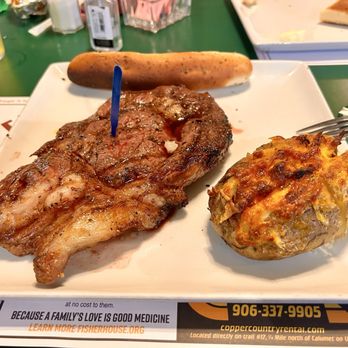 Foggy's Steakhouse - 16oz Ribeye with loaded baked potato - Sports Bars Near Me - Christmas, Michigan Foggy's Steakhouse - 16oz Ribeye with loaded baked potato - Sports Bars Near Me - Christmas, Michigan