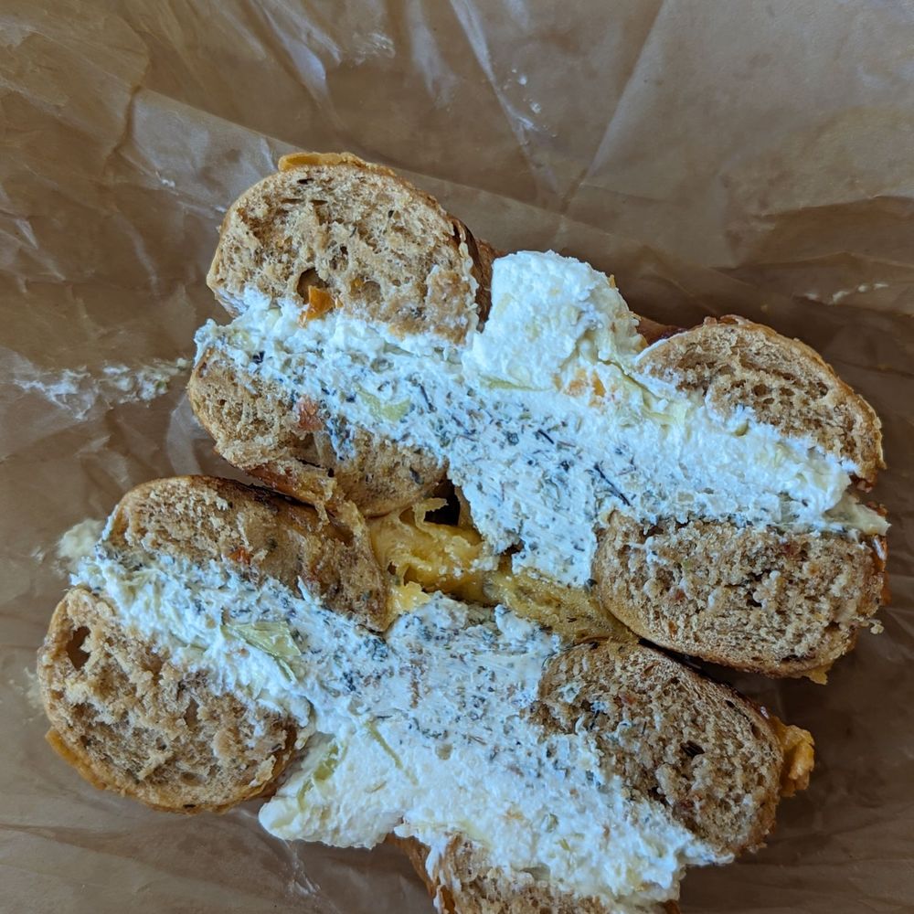 Tomato cheddar bagel w/ garden veggie + artichoke Parmesan cream cheese