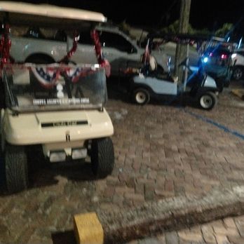 Edgewater Lodge - Golf carts from the other community next to the resort parking in the handicap and in other people's parking space - Hotels Near Me - Long Key, Florida
