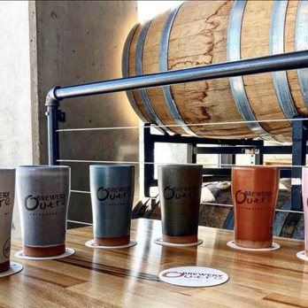 Brewery Outré - a row of coffee cups on a table - Breweries Near Me - Kalamazoo, Michigan