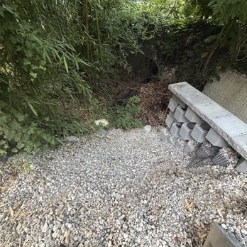 AP Paving & Masonry - Rock eroding into the stream because the ends weren't capped off . Bags of cement and block left behind - Masonry/Concrete Near Me - Wayne, Pennsylvania