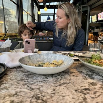 Earls Kitchen + Bar - Mac'n cheese and some bread with some of the restaurant in the background - New American Near Me - McLean, Virginia Earls Kitchen + Bar - Mac'n cheese and some bread with some of the restaurant in the background - New American Near Me - McLean, Virginia