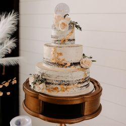 Nana’s Bakery - Chocolate wedding cake with salted caramel, extreme strawberry and peanut butter fillings, vanilla frosting with gold leaf and fresh flowers