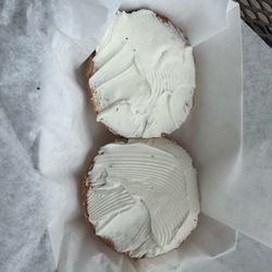 Toasted plain bagel with cream cheese.
