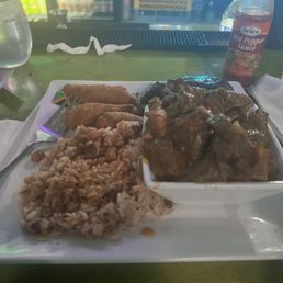 Curry goat, festival and rice and peas Curry goat, festival and rice and peas