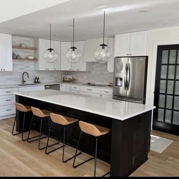 Pine State Contracting - White Shaker Kitchen Cabinets. Black Shaker island. Marble Quartz countertops. White Oak LVP flooring - General Contractors Near Me - Spartanburg, South Carolina Pine State Contracting - White Shaker Kitchen Cabinets. Black Shaker island. Marble Quartz countertops. White Oak LVP flooring - General Contractors Near Me - Spartanburg, South Carolina