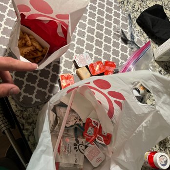 Chick-fil-A - ows a person grabbing a bag of food - Fast Food Near Me - Conroe, Texas