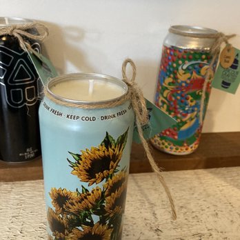 Crompton Collective - A sunflower-themed candle in a tall container with a twine bow, set on a wooden surface, with two decorated jars in the background. - Used, Vintage & Consignment Near Me - Worcester, Massachusetts