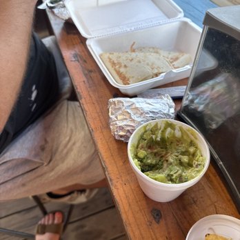 Mr Tacos - a man sitting at a table with food - Food Stands Near Me - Mount Enterprise, Texas