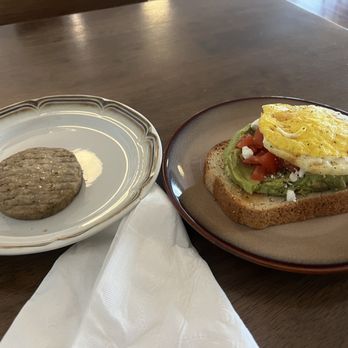 The Pharmacy Coffeehouse - Tomato Feta Avocado Toast with a fried egg and a piece of sausage :) - Coffee & Tea Near Me - Bartlett, Tennessee