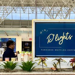 Mini Delights - Name of establishment side view & associate looking around.