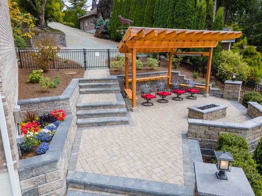 Lakeside Getaway - This project was nothing but a steep gravel decent to the lake before we worked closely with our client to design and build this amazing terraced patio with a custom built pergola and gas fire place for the cherry on top! Lakeside Getaway - This project was nothing but a steep gravel decent to the lake before we worked closely with our client to design and build this amazing terraced patio with a custom built pergola and gas fire place for the cherry on top!