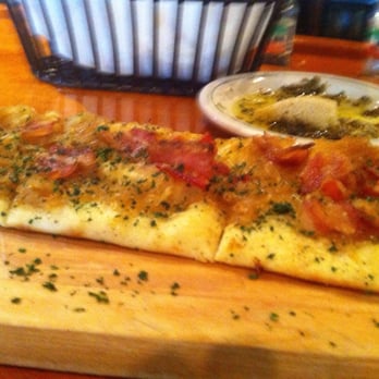 Carrabba's Italian Grill - Flat bread pizza from wood fired oven - you can see a side of olive oil and herbs too! - Italian Near Me - Johnson City, Tennessee Carrabba's Italian Grill - Flat bread pizza from wood fired oven - you can see a side of olive oil and herbs too! - Italian Near Me - Johnson City, Tennessee