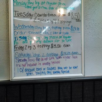 Pizza Pit Stop - Their white board behind the cashier with their daily specials. - Pizza Near Me - Strasburg, Colorado