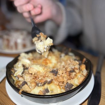 The Mayfly - a person holding a fork over a dish of macaroni and cheese - American Near Me - New York, New York The Mayfly - a person holding a fork over a dish of macaroni and cheese - American Near Me - New York, New York