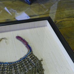 Blue Dot Picture Framing - Antique necklace displayed in a fabric wrapped shadow box (float mount) in a modern black wood frame