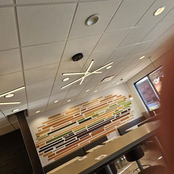 McDonald's - a long table with chairs and a television - Fast Food Near Me - Mount Laurel, New Jersey