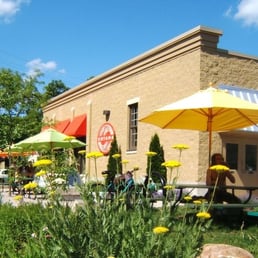 tables and umbrellas in front of a building