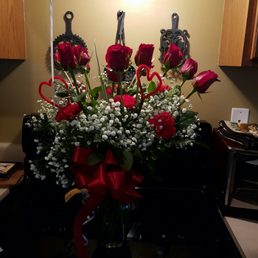 A dozen roses with carnations and baby's breath.