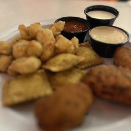 a plate of food with dipping sauces a plate of food with dipping sauces