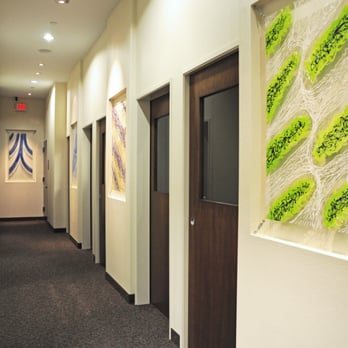 Paragon Dentistry - Main hallway to treatment rooms with art gallery.  All our treatment rooms have pocket doors for your privacy! - General Dentistry Near Me - Allen, Texas